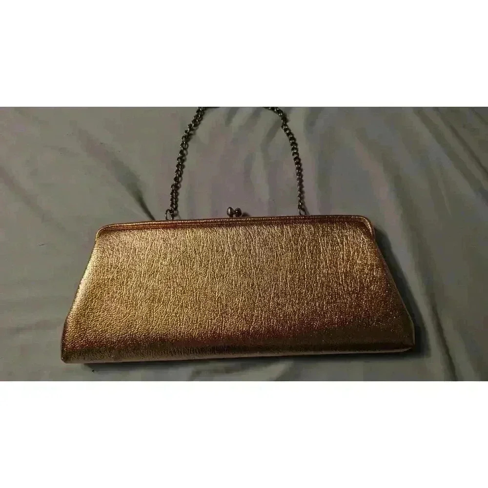 Women's gold clutch circa 1960s with gold chain and  kiss lock closure no brand